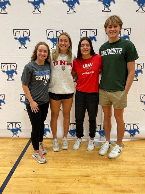 Mariana Diaz Ponce, Logan Pack, Katherine Brunner and Makenna Holloway post for a photo at Taylor's signing day ceremony.